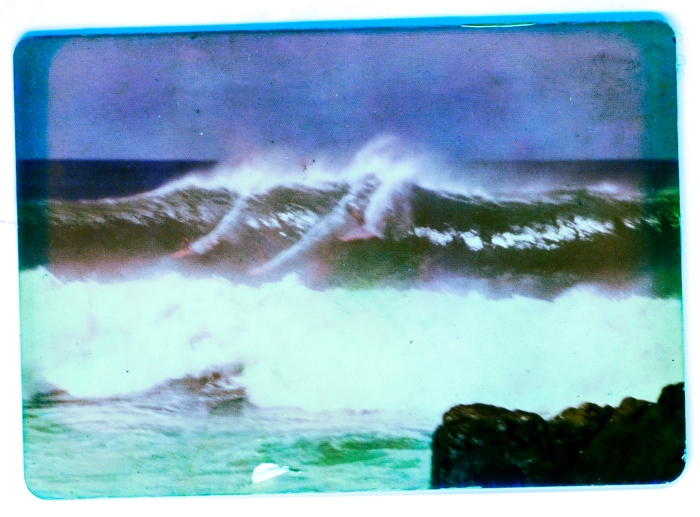 Blurry, but if you look close you can see me, in back, spinning out. Bounced off the bottom all the way outside. Waimea, 1973.